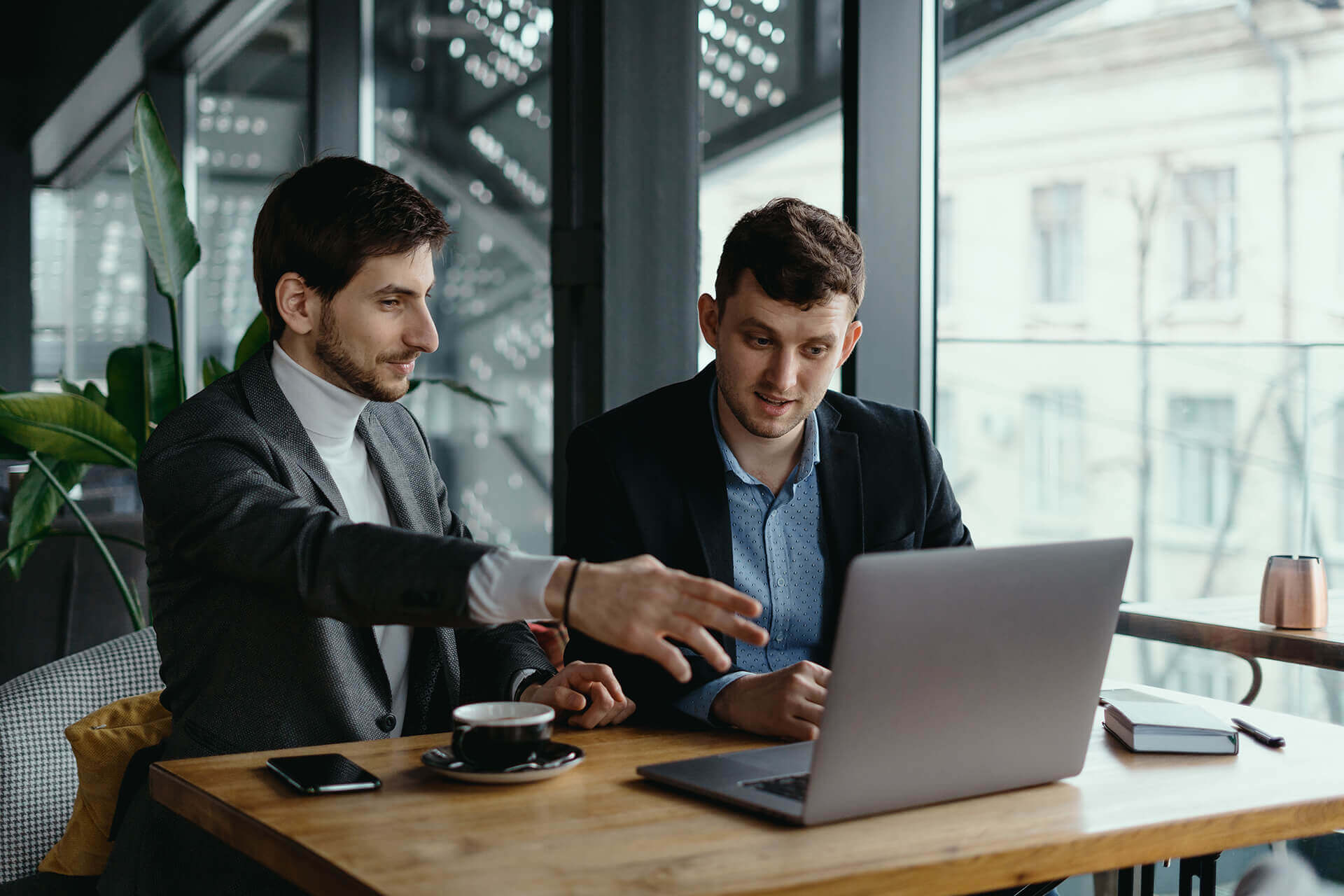 Two colleagues working together on a laptop