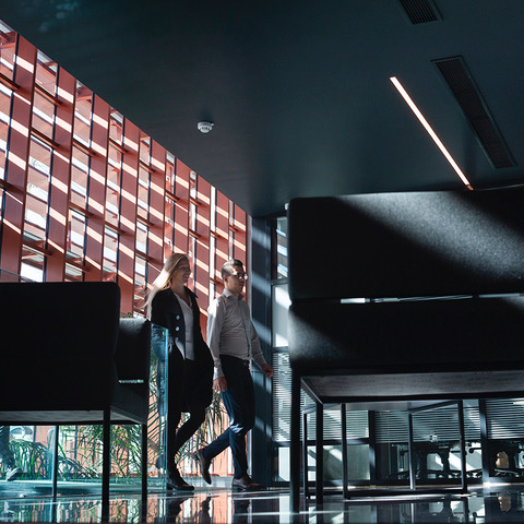 Two colleagues walking through an office lobby